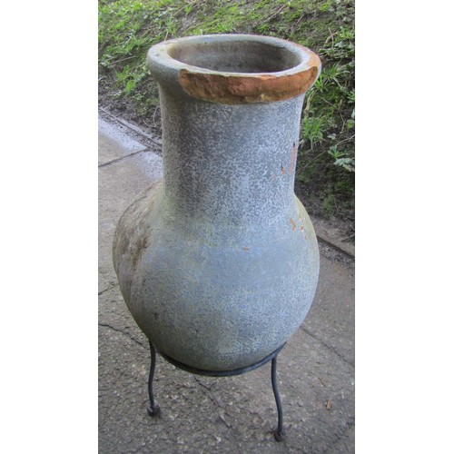 1010 - A small chimenea raised on a simple steel stand (af), 66 cm high