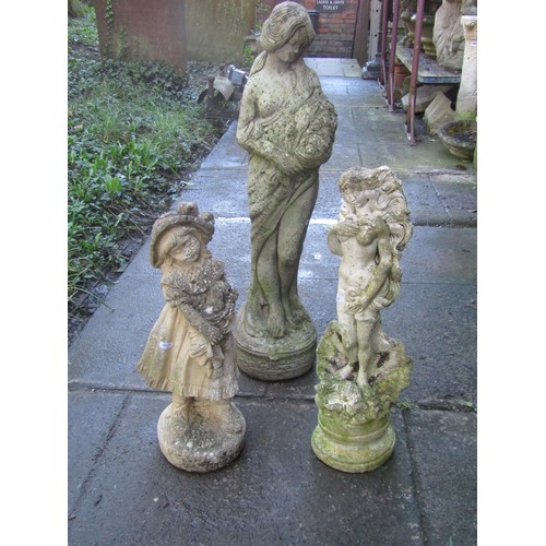 1009 - Three weathered cast composition stone garden ornaments, two maidens of varying design, the largest ... 