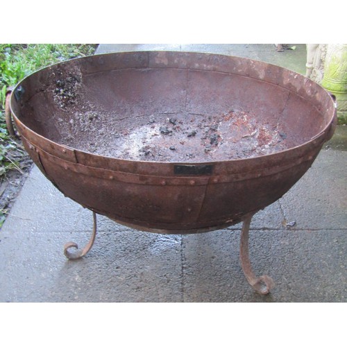 1016 - A weathered Kadai riveted iron fire pit and stand, 71cm diameter x 43cm high