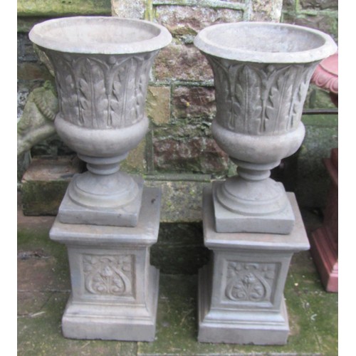 1031 - A pair of  cast composition stone trumpet shaped vases with repeating acanthus leaf detail and fixed... 