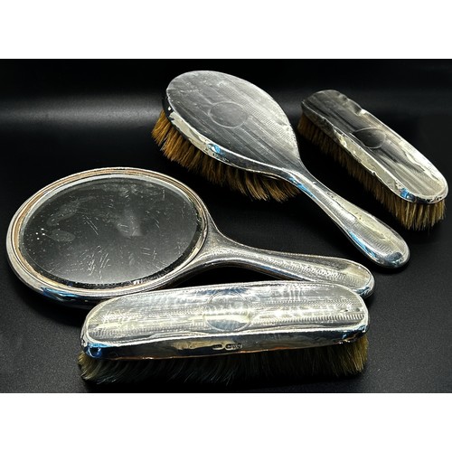 199 - An assortment of six silver backed brushes and a single silver hand mirror (7)