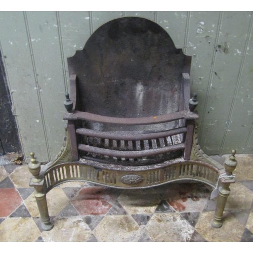 1051 - A Georgian style cast iron and brass fire basket with serpentine front 61 cm (full width) together w... 