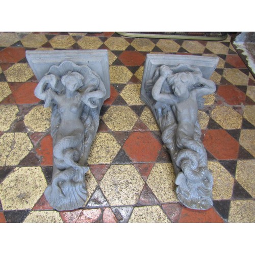 1062 - A pair of cast composition stone corbels with mermaid and merman detail, 52 cm high x 31 cm wide