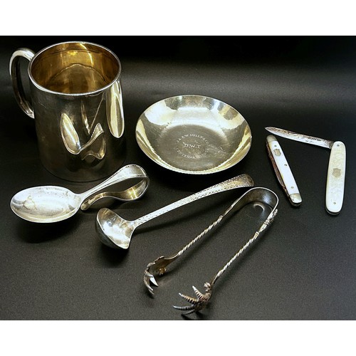 206 - A mixed collection of silver items to include  pen tray, christening mug, a centenary dish, a sauce ... 