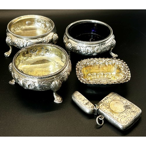 170 - Three matching Victorian silver salt cauldrons with floral scrolling on thee pad feet, London 1872, ... 