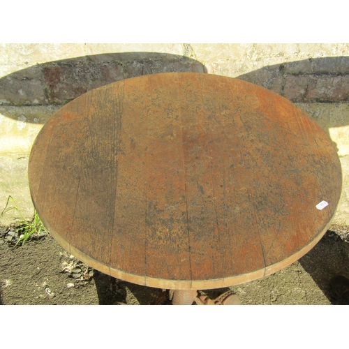 1070 - Pair of circular wooden topped pub tables raised on cast iron bases with entwined stylised dolphin d... 