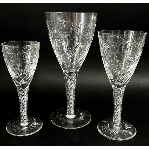 139 - A suite of good quality cut glass drinking glasses with foliate decoration, on quadruple helix stems... 