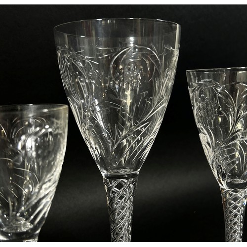 139 - A suite of good quality cut glass drinking glasses with foliate decoration, on quadruple helix stems... 