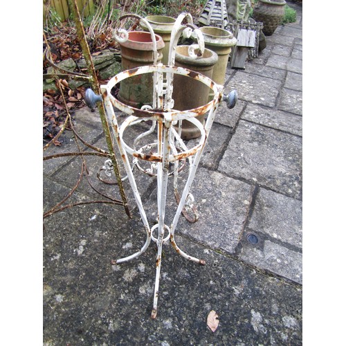 1021 - A painted and weathered vintage saucepan stand, a cast iron table base with scrolling supports and a... 