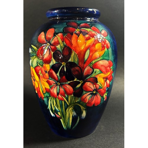 114 - A Moorcroft floral porcelain vase, signed to underside