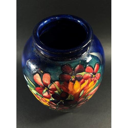 114 - A Moorcroft floral porcelain vase, signed to underside