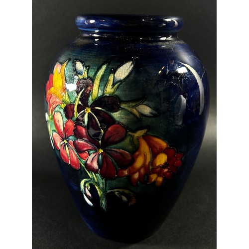 114 - A Moorcroft floral porcelain vase, signed to underside