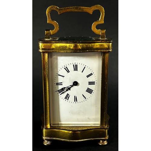 442 - A brass carriage clock set within a shaped case with enamelled dial and eight day timepiece, current... 