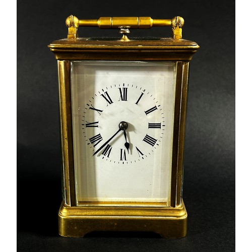 440 - A brass carriage clock with eight day striking movement with repeat, currently running