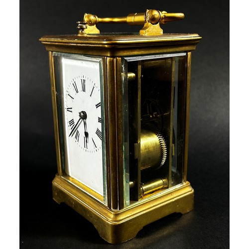 440 - A brass carriage clock with eight day striking movement with repeat, currently running