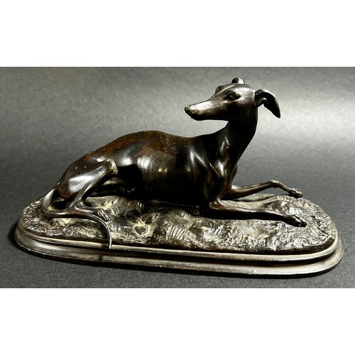 541 - A small bronze recumbent whippet, 21cm from nose to tail (base length) together  with a bronzed resi... 