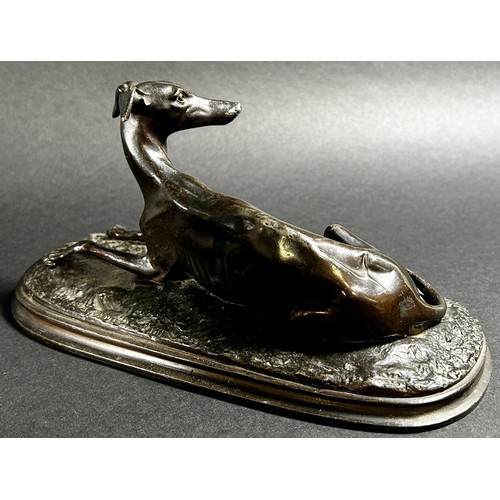 541 - A small bronze recumbent whippet, 21cm from nose to tail (base length) together  with a bronzed resi... 