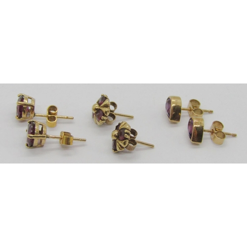 241 - Three pairs of 9ct gem set stud earrings; a pear-cut amethyst pair and two garnet pairs, 4.1g total ... 