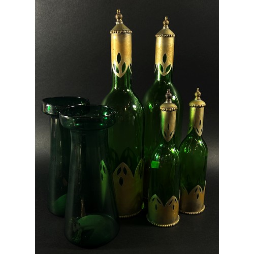 144 - A mixed decorative collection to include four bottle green bottles with metal sleeves a pair of gree... 