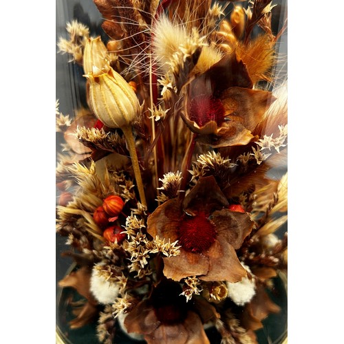 540 - A dried flower arrangement in glass dome display, a pair of porcelain powder tubes, a small magnifyi... 