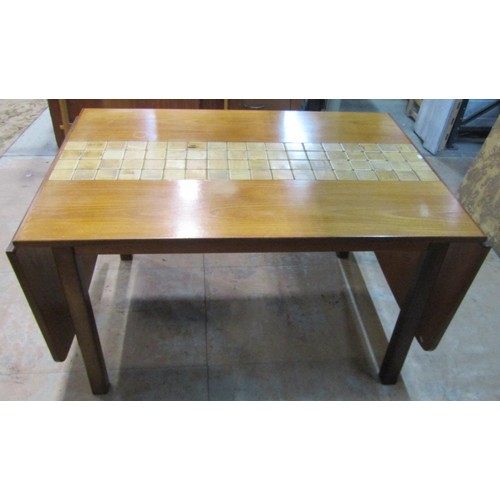 1146 - A mid 20th century G plan teakwood extending drop leaf table , the central section enclosing ceramic... 