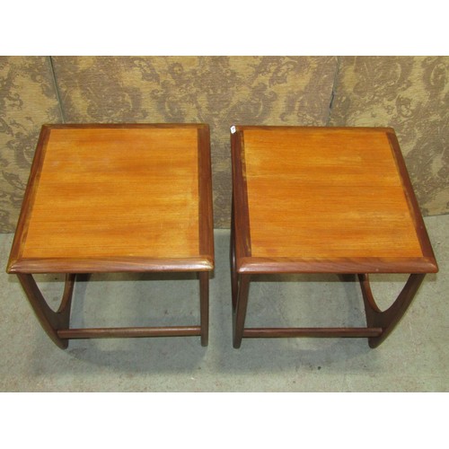 1169 - A pair of G plan teakwood occasional tables of square cut form on horseshoe shaped supports