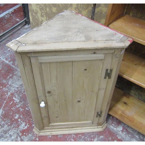 1081 - A stripped and waxed pine hanging corner cupboard with panelled door, a flight of open shelves and a... 