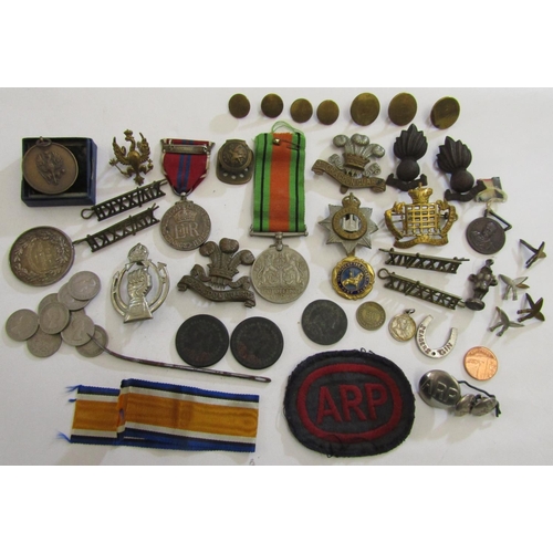 876 - A box of regimental cap badges, defence medal, ARP badges etc