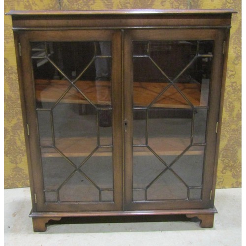 1172 - A Georgian style mahogany bookcase enclosed by two astragal glazed panelled doors