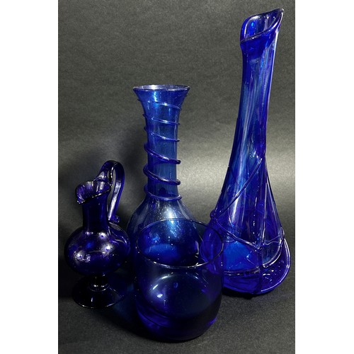 149 - A collection of eight Bristol Blue glassware vases in varying designs.