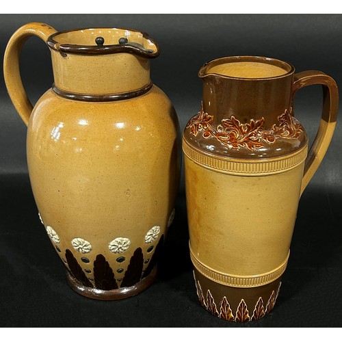 82 - A Doulton Lambeth brown glazed jug with loop handle and applied geometric detail, with pewter lid an... 