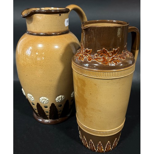 82 - A Doulton Lambeth brown glazed jug with loop handle and applied geometric detail, with pewter lid an... 