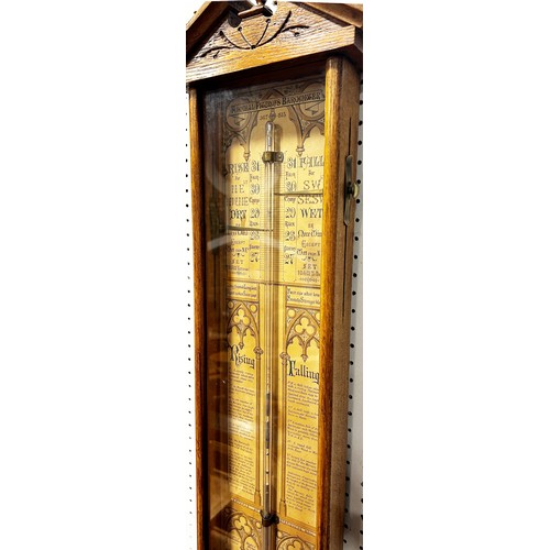 466 - A 19th century Admiral Fitzroy barometer with oak case, the back plate with printed detail and Gothi... 