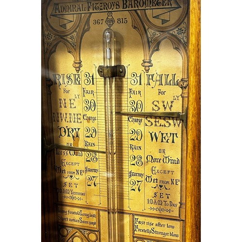 466 - A 19th century Admiral Fitzroy barometer with oak case, the back plate with printed detail and Gothi... 