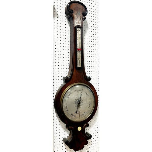 467 - A mid-19th century rosewood barometer with silvered dials and further applied carving by W. Johnson ... 