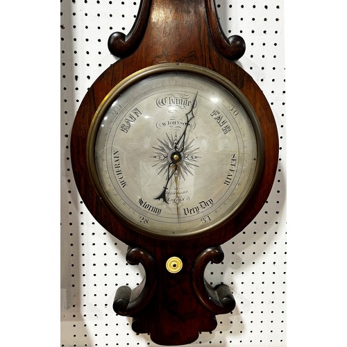 467 - A mid-19th century rosewood barometer with silvered dials and further applied carving by W. Johnson ... 