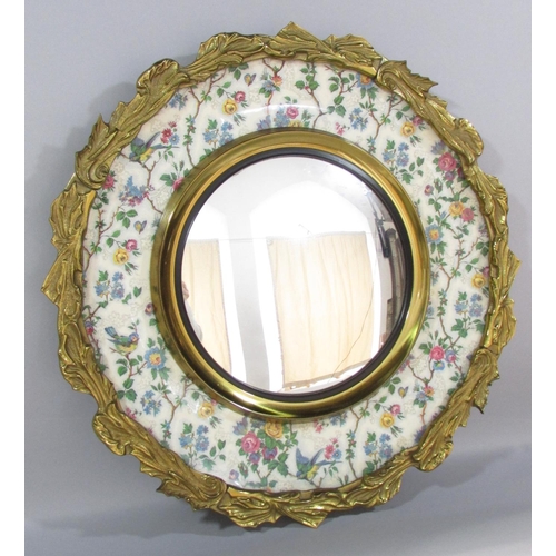 472 - An ormolu mounted convex mirror set in Burslem plate decorated with roses & birds and an outer frame... 