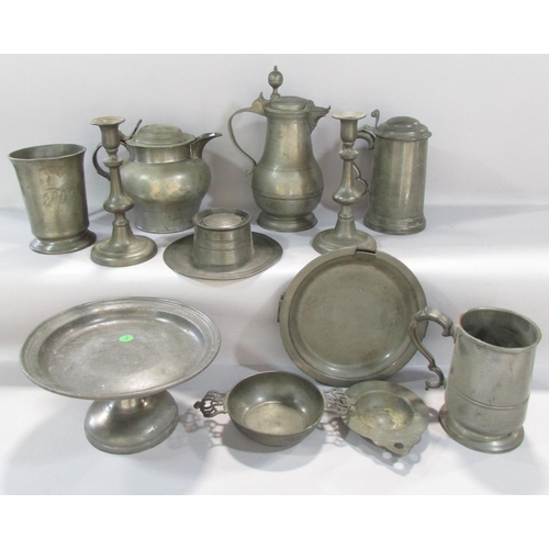 478 - A varied selection of early 19th century pewter table ware, including tankards, jugs, a pair of cand... 