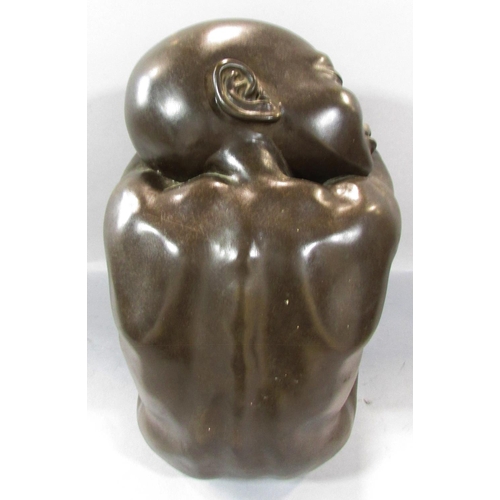 493 - A bronze effect resin study of a naked figure, sleeping on arms resting on drawn up knees, 34cm high... 