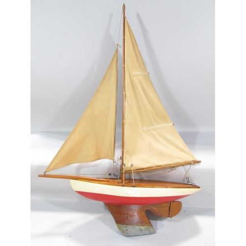 496 - A vintage single mast pond yacht, with a lead re-enforced keel, 60cm long x 85cm high, and a framed ... 