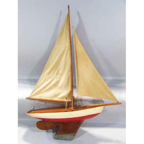 496 - A vintage single mast pond yacht, with a lead re-enforced keel, 60cm long x 85cm high, and a framed ... 