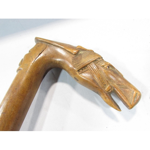 497 - A walking stick with a carved head of a bridled horse handle, with an indistinct stamp, 83cm.