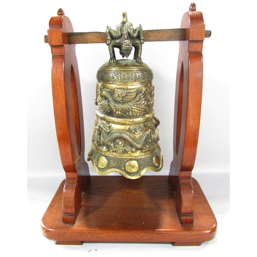 498 - A Bronze Chinese Temple Dragon Gong hung from a wooden stand, 48cm x 40cm.