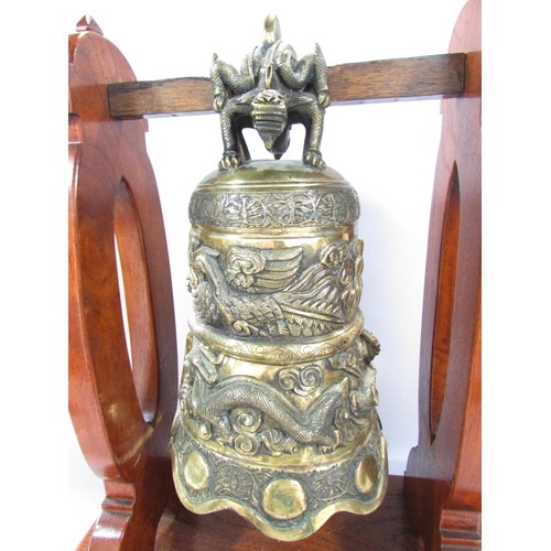 498 - A Bronze Chinese Temple Dragon Gong hung from a wooden stand, 48cm x 40cm.