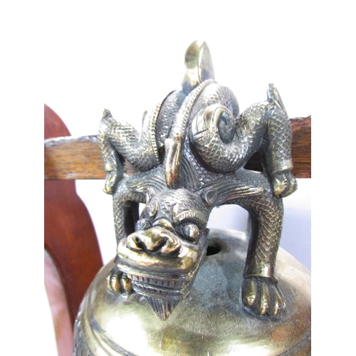 498 - A Bronze Chinese Temple Dragon Gong hung from a wooden stand, 48cm x 40cm.