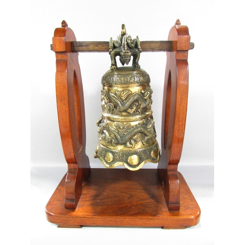 498 - A Bronze Chinese Temple Dragon Gong hung from a wooden stand, 48cm x 40cm.