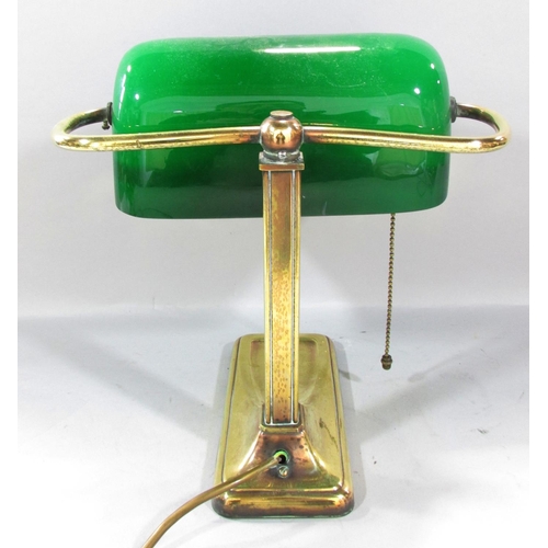 501 - A Brass bankers lamp with a swivel green glass shade. 28cm high.