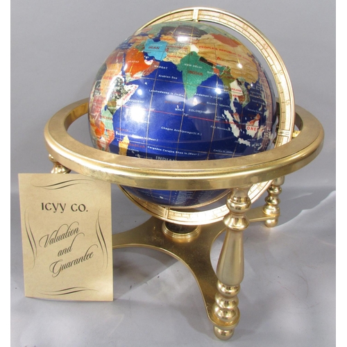 506 - An ICYY Co. Gemstone Globe, with countries picked out in various semi-precious stone, set on a brass... 