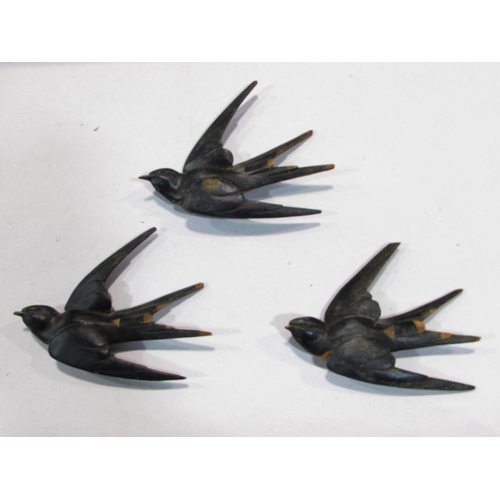 511 - Nine wooden swallows in flight, of varying sizes, with a nest and two fledglings,  possibly from a m... 