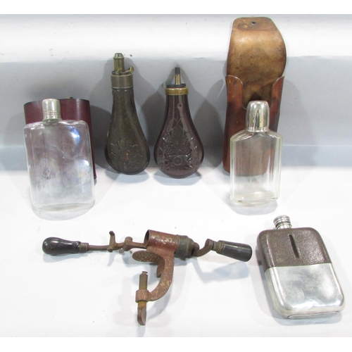 512 - Three hip flasks, an antique 12 bore cartridge crimper, and two antique powder flasks.